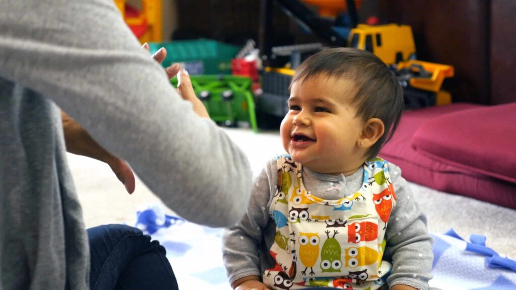 Child with hearing loss wearing a LENA vest