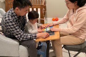 Our family coaching model encourages families to take the lead in their child's development. The family in the photo above is engaging with their child by reading to them.