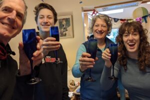 The Pottharst-Ralston Family celebrating and drinking a beverage. From left to right: Ed, Danny, Elizabeth, Amy