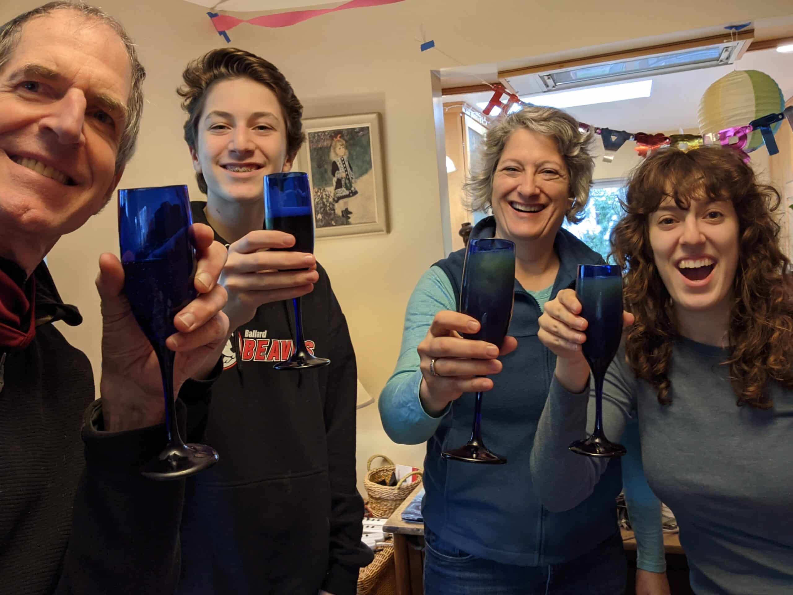 The Pottharst-Ralston Family celebrating and drinking a beverage. From left to right: Ed, Danny, Elizabeth, Amy