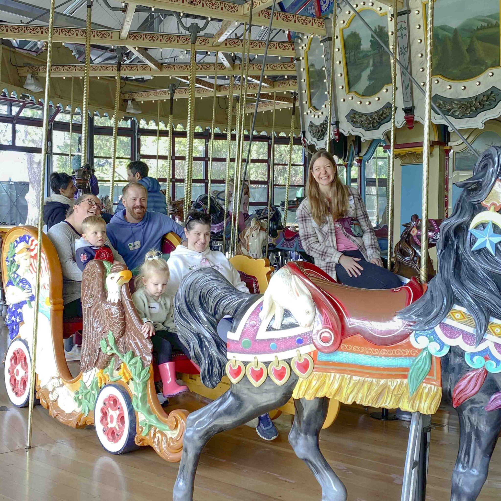 Two families ride carousel with B3 Provider, Meghan