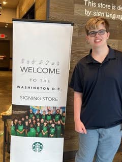 Dalton visited the Signing Starbucks store in Washington, D.C. and he's posing next to the banner here.