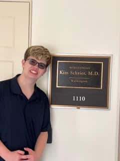 Dalton posing in front of Legislator Kim Schrier's sign in Washington, D.C.